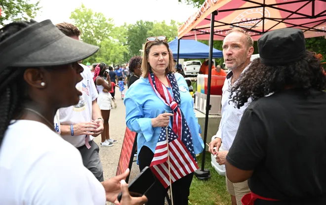 U.S. Rep Elissa Slotkin. left, and Oakland County Executive Dave Coulter greet supporters on July 4 in Shepherd Park after Oak Park's Fourth of July Parade.